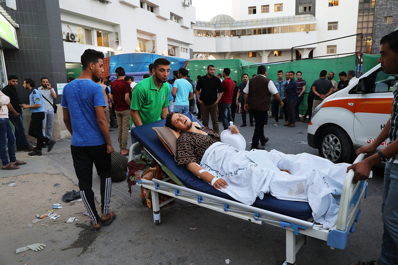 GAZA CITY, GAZA - MAY 14: The wounded sit in a parking lot outside of Gaza's main hospital due to an overflow of patients on May 14, 2018 in Gaza City, Gaza. Israeli soldiers killed over 50 Palestinians and wounded over a thousand as demonstrations on the Gaza-Israel border coincided with the controversial opening of the U.S. Embassy in Jerusalem. This marks the deadliest day of violence in Gaza since 2014. Gaza's Hamas rulers have vowed that the marches will continue until the decade-old Israeli blockade of the territory is lifted. (Photo by Spencer Platt/Getty Images)
